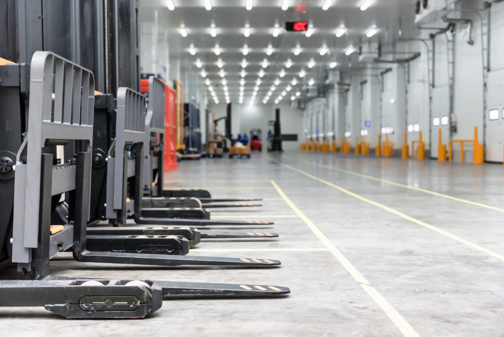 Loading area in the warehouse cold room with forklift standing